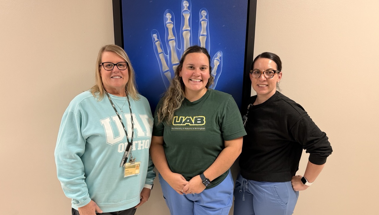 Clinic coordinators pose together in a clinic.