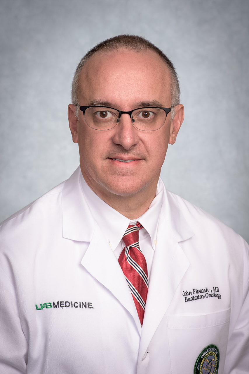Headshot of Dr. John Fiveash, MD (Professor/Vice Chairman, Radiation Oncology) in white medical coat, September 2023.