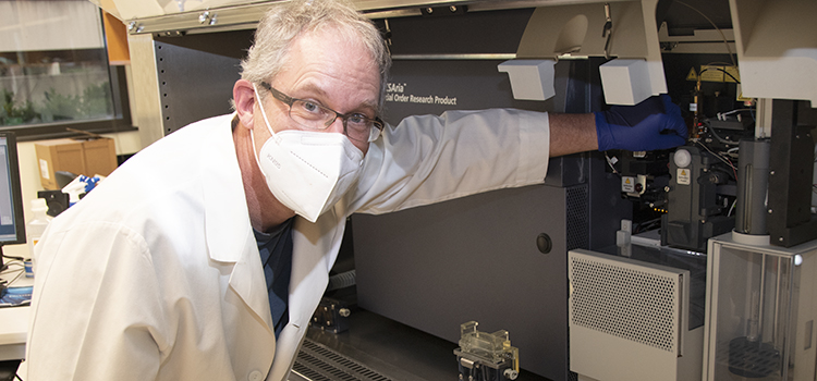 Dr. Troy Randall with cytometry equipment.