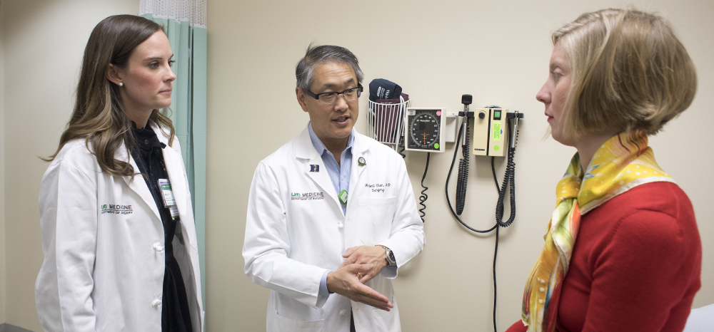 Nurse practitioner Kelly Lovell and Department of Surgery Chair Dr. Herbert Chen speak with thyroid cancer patient Ragan Cain. 