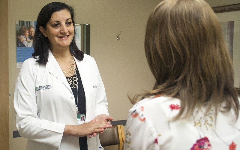 Director of the Division of Surgical Oncology Dr. Helen Krontiras speaks to a patient in the clinic at UAB.
