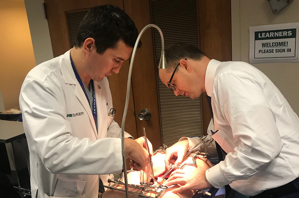 Vascular surgery integrated resident and fellow Dr. William Jackson completes a simulation activity with Division of Vascular Surgery and Endovascular Therapy Director Dr. Benjamin Pearce.