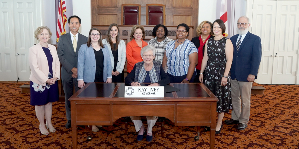 Associate Director of Health Services Research Dr. Daniel Chu and general surgery residents Drs. Samantha Baker and Lauren Theiss attend Proclamation Day on Sept. 16 in Montgomery, Alabama, to welcome Health Literacy Month with Gov. Kay Ivey. (Photo via governoriveyphotos.com) 