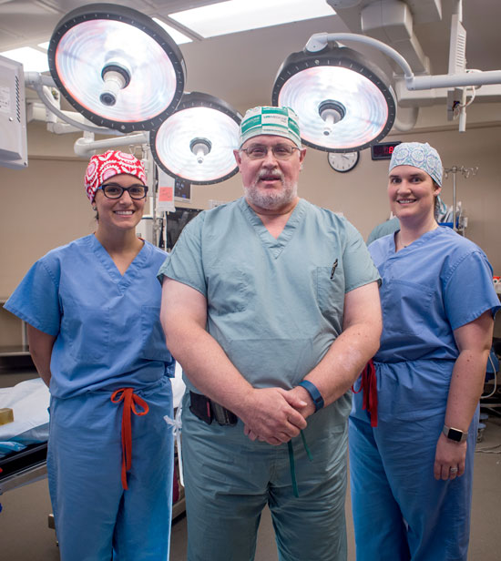 Dr. Margaux Mustian, left, and Dr. Laura Hickman, right, say they pursued a career in transplant surgery in part due to the teaching and training they received from longtime UAB transplant surgeon Dr. Mark Deierhoi.