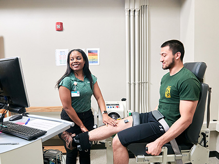 Exercise Physiologist Grace Cunningham overseeing Muscle Function tests of researcher Ali El-Husari at the Exercise Clinical Trials Facility's Neuromuscular Function Laboratory.