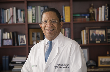 Environmental head shot of Dr. Selwyn Vickers, MD (Senior VP, Medicine; Dean, Medicine) in white medical coat in his office, 2018.