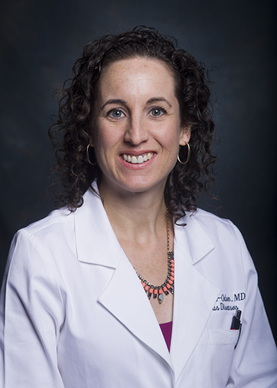 Head shot of Dr, Jodie Dionne-Odom, MD (Assistant Professor, Infectious Diseases) in white medical jacket (2013).