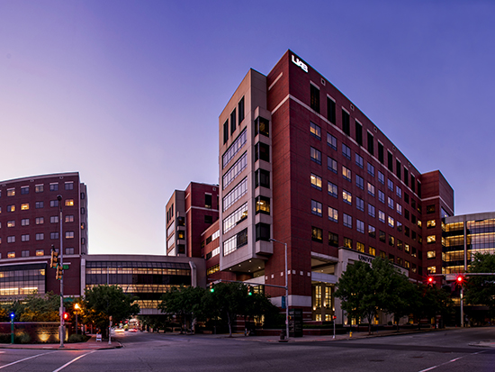 Exterior of UAB medical center buildings including the Benjamin Russell Hospital for Children - Children's of Alabama, the Women and Infants Center, Hazelrig-Salter Radiation Oncology Center, the North Pavilion, O'Neal Comprehensive Cancer Center, the Wallace Tumor Institute, and the General Services Building of the UAB School of Medicine at dusk, April 2020.