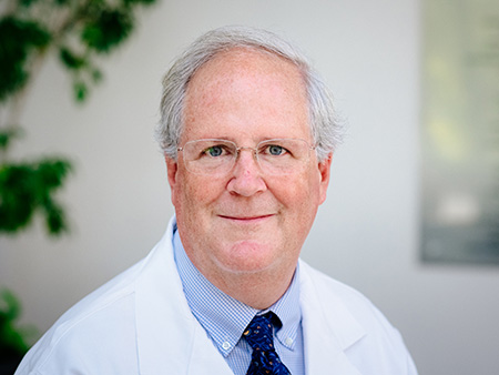Environmental headshot of David Standaert, MD (Professor/Chairman, Neurology) in white medical coat, 2019.