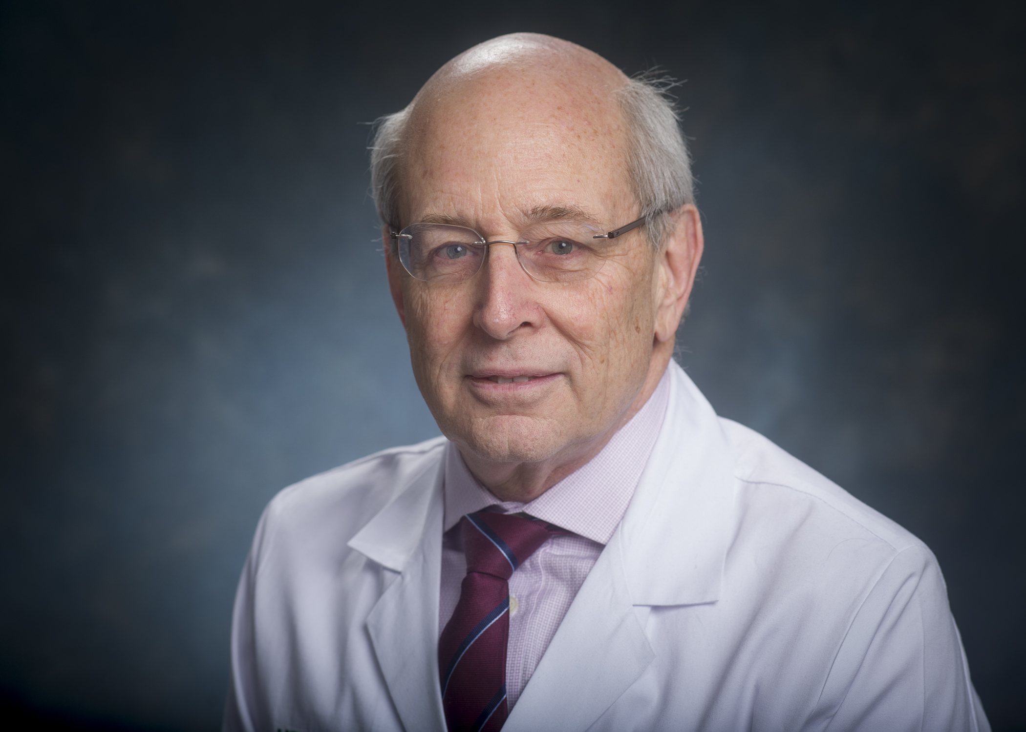 Head shot of Dr. Ronald Lazar, MD (Professor, Neurology) in white medical coat, 2018.