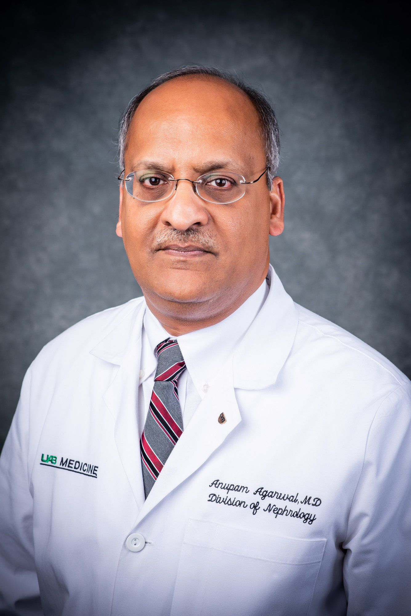 Head shot of Dr. Anupam Agarwal, MD (Professor and Director, Nephrology) in white medical coat, 2018.