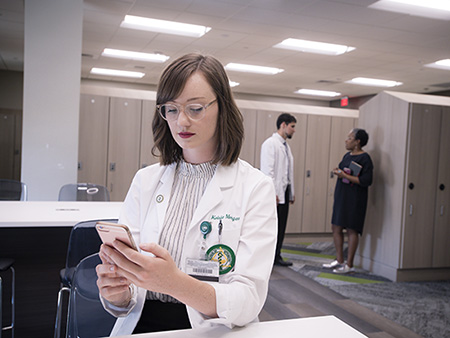 Kelsie Morgan (Student, Optometry) is standing in renovated Student Locker Room on the 3rd Floor of the Henry Peters Building School of Optometry, 2018.