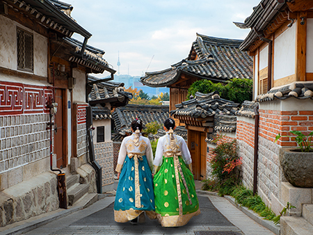 Two women walking through a village in South Korea