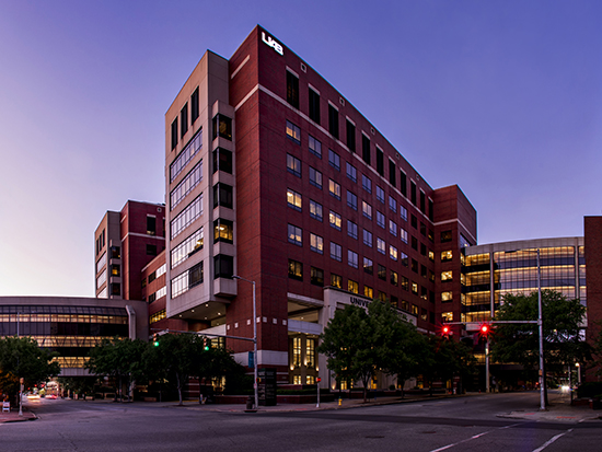 Exterior of UAB medical center buildings including the Benjamin Russell Hospital for Children - Children's of Alabama, the Women and Infants Center, Hazelrig-Salter Radiation Oncology Center, the North Pavilion, O'Neal Comprehensive Cancer Center, and the Wallace Tumor Institute at dusk, April 2020.