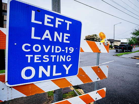 A blue street sign that reads "Left Lane Covid-19 Testing Only" near the Downtown COVID-19 Testing Site sponsored by UAB Medicine and the Jefferson County Department of Health on March, 23, 2020.
