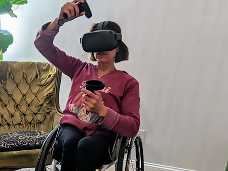 Child with disability playing virtual reality game. 