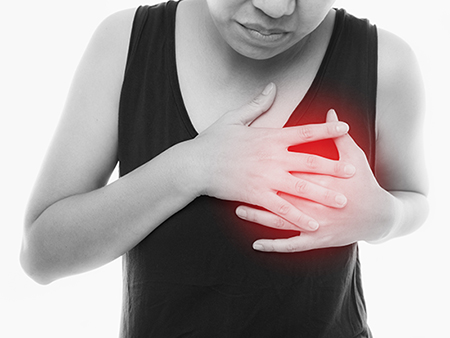 Woman having a pain in the heart area with red alert accent on white background