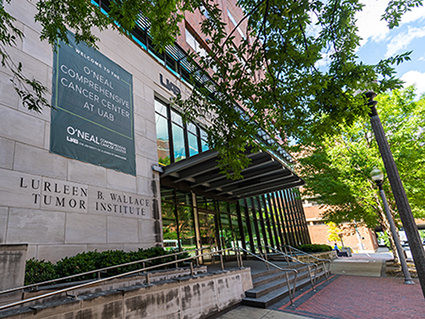Large green O'Neal Comprehensive Cancer Center banner is hanging on exterior wall of the Lurleen B. Wallace Tumor Institute/UAB Comprehensive Cancer Center, 2019.