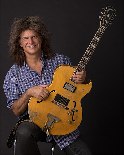 A photo of Pat Metheny with a guitar 