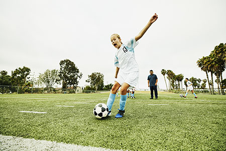 Young girl playing soccer