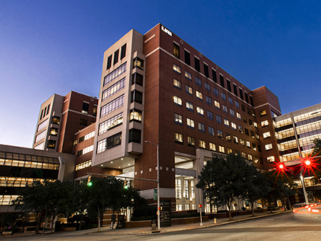 Exterior of the North Pavilion of UAB Hospital at dusk, April 2020.