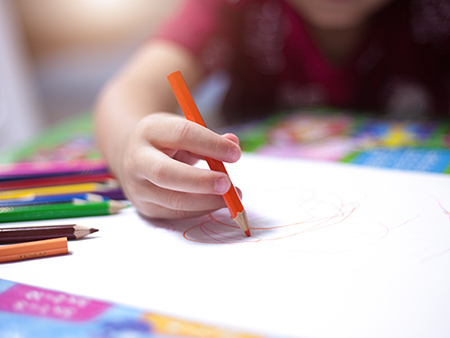 a boy drawing with colourful crayon ,kids Coloring
