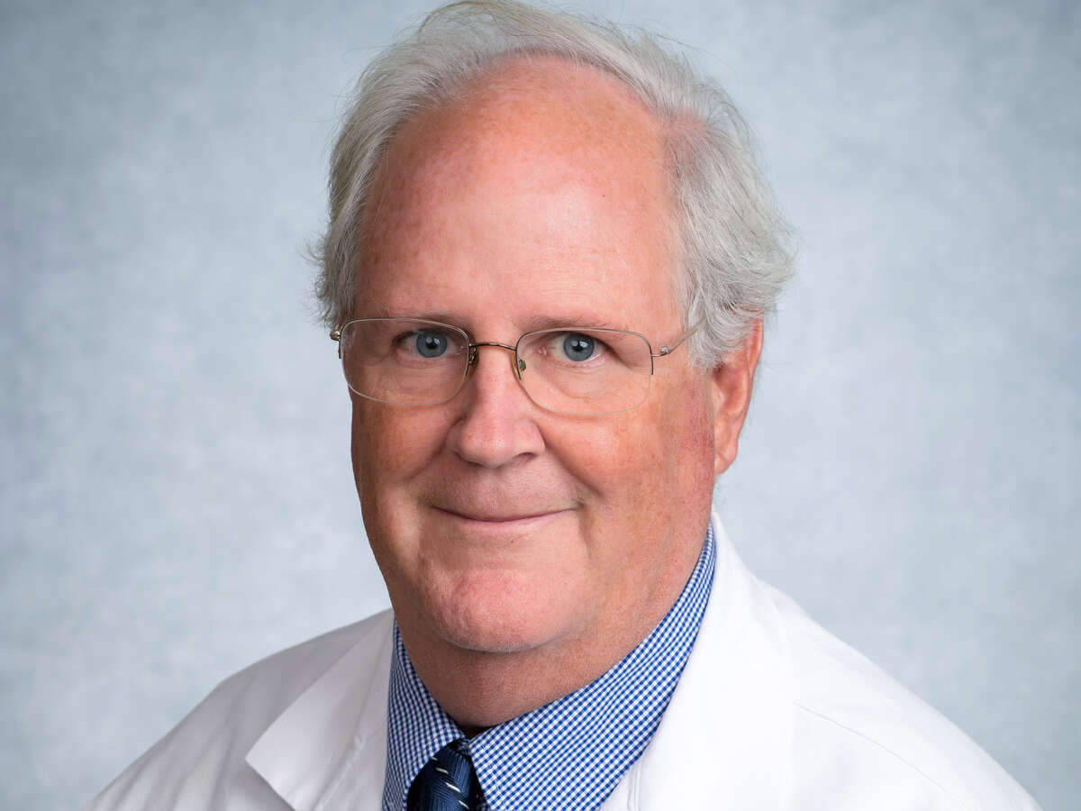 Headshot of Dr. David G. Standaert, M.D., Ph.D, professor and chair of Department of Neurology in white medical coat
