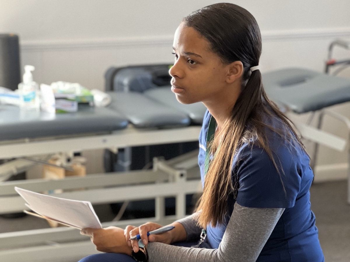 Malia McDowell, O.D., sitting in a clinical, indoor setting
