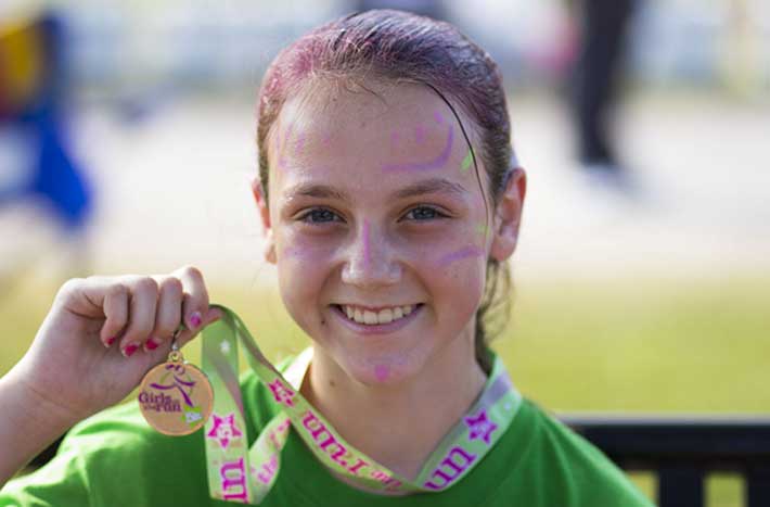 Girl showing off her medal