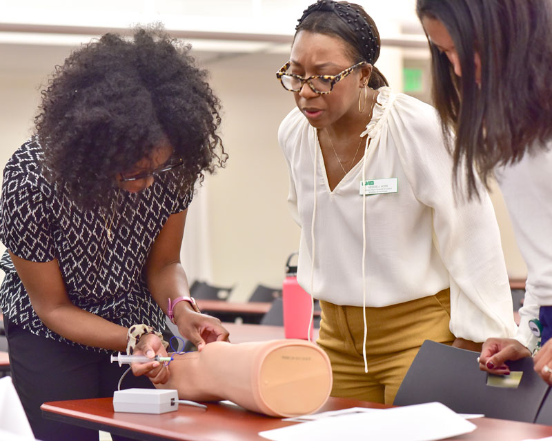 Three students practicing during an on-campus intensive.