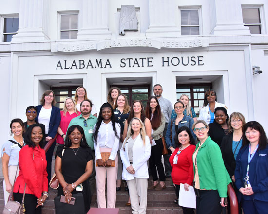 Group photo with the state capital building in the backdrop