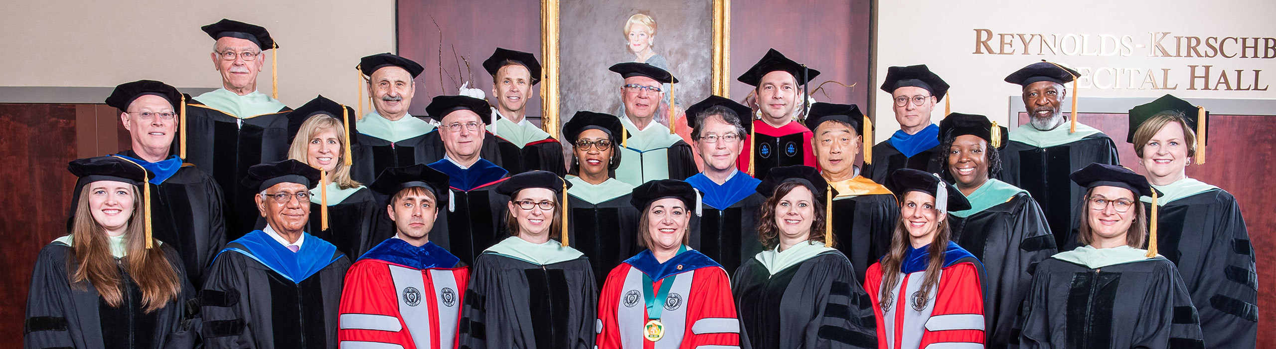 Large group of UAB Optometry faculty dressed in academic regalia.
