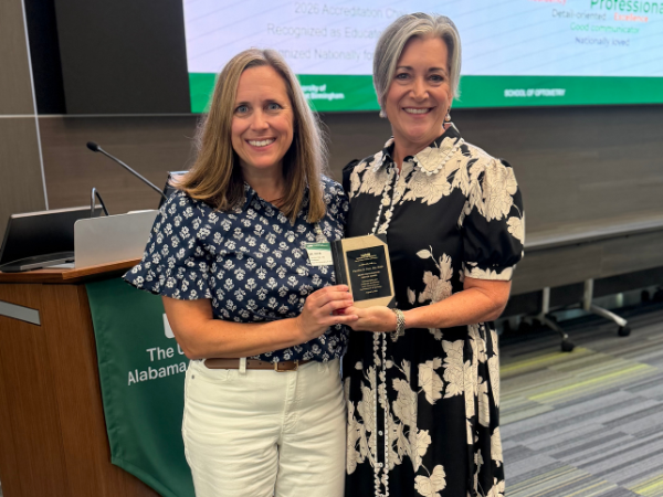 Photo of Dr. Caroline Pate receiving her Dean's Distinguished Service Award from Dean Kelly Nichols.