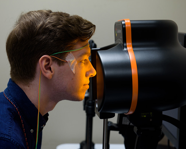 A person using a research imaging equipment