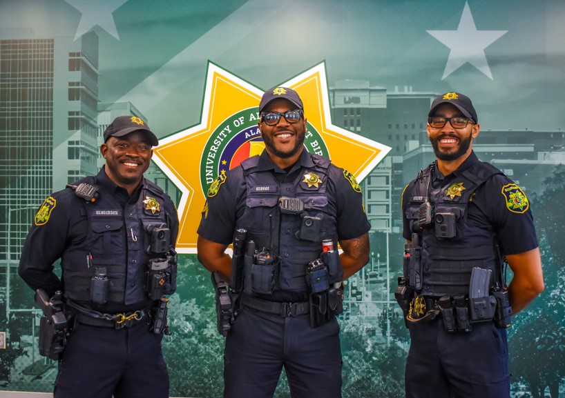 UAB Police Officers pose in front of the police star