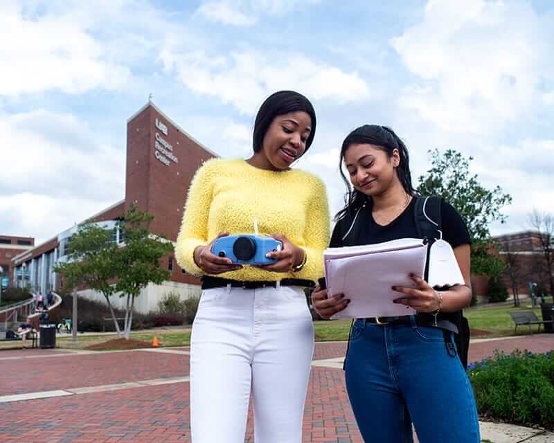 Two students conducting a research study on the UAB campus. 
