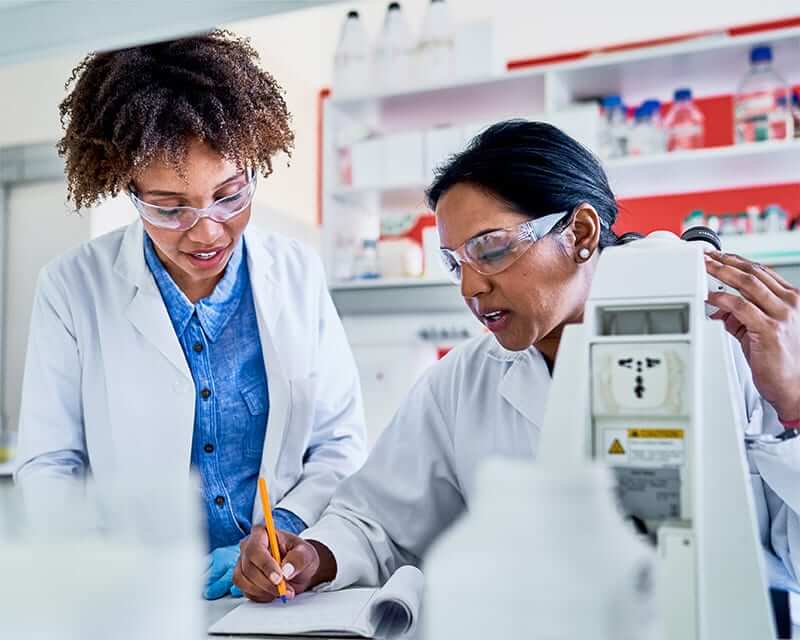 A mentor and mentee working in a research lab. 