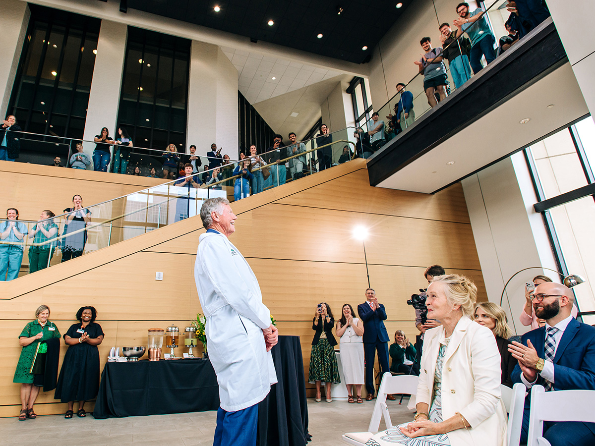 Dr. Heersink smiles as the audience in the Volker Hall atrium applauds during the anniversary celebration of the UAB Heersink School of Medicine