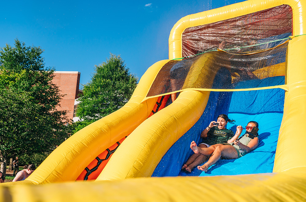 A UAB employee and a UAB student go down a waterslide at Blazer Splash
