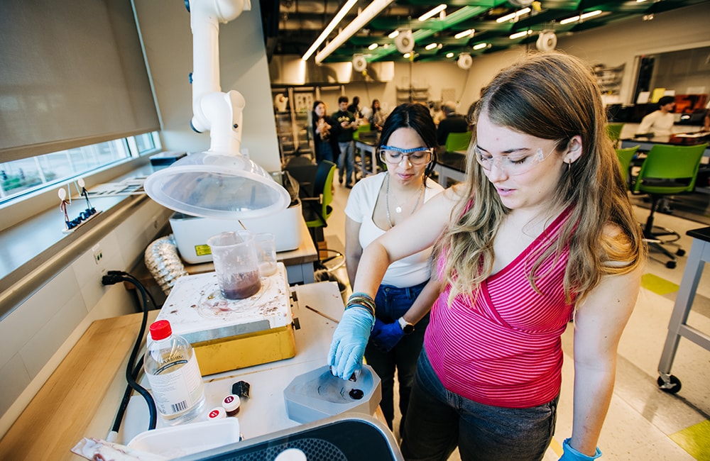 Amelia Hunt and Eva German Garcia mix materials while developing their project in the Design x Prototyping Lab