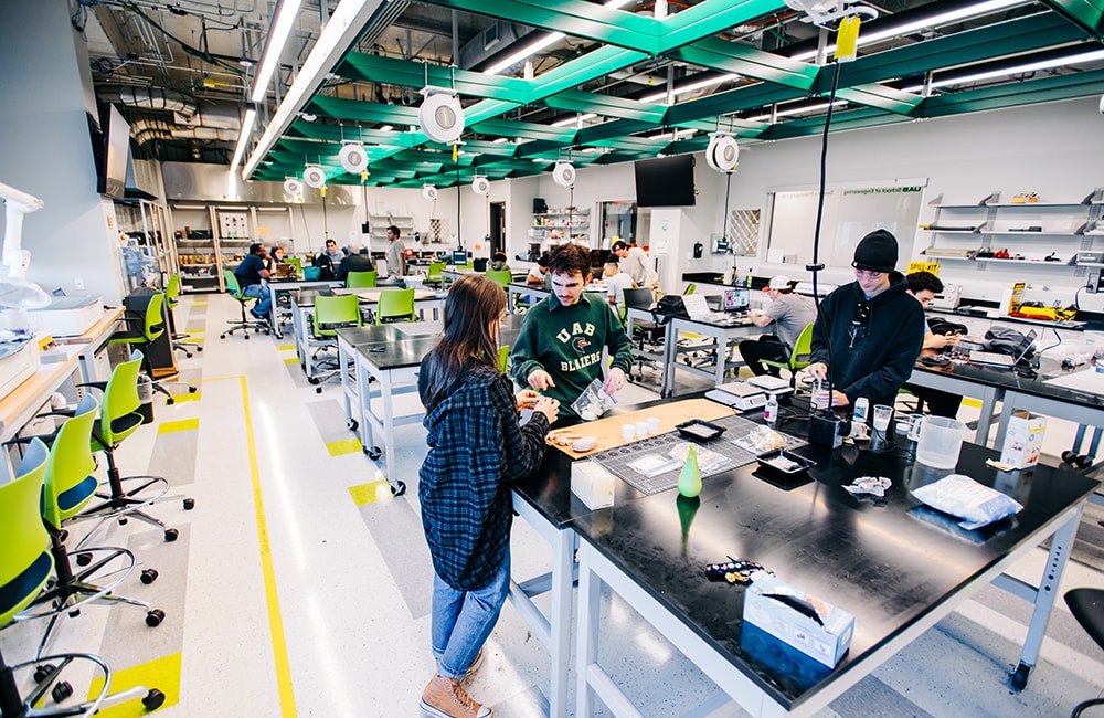 Another angle of the Design x Prototyping Lab, showing students at work on projects.