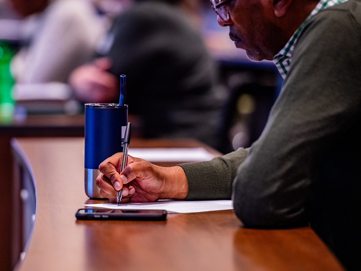 UAB employee takes notes at an on-campus meeting