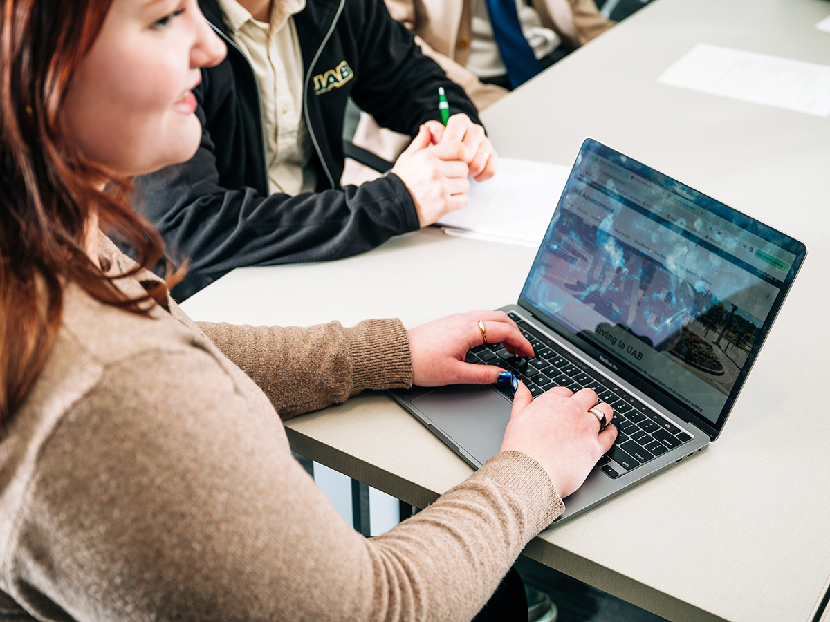 UAB employee uses laptop at meeting