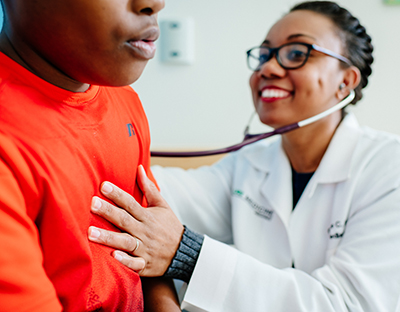 Unidentified black female pediatric doctor is examining a black male pediatric patient at the UAB Pediatric Primary Care Clinic, 2019.