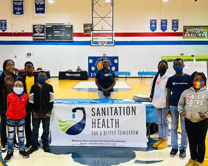  Residents gathered around a Sanitation Health informationt table