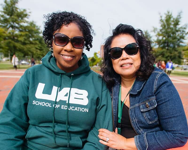 Two UAB faculty members on the campus green.