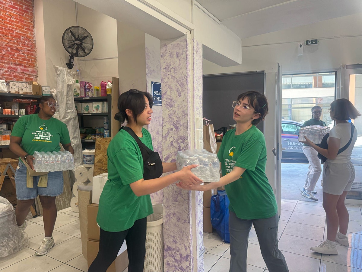 Student passing water pallets in a fireman formation.