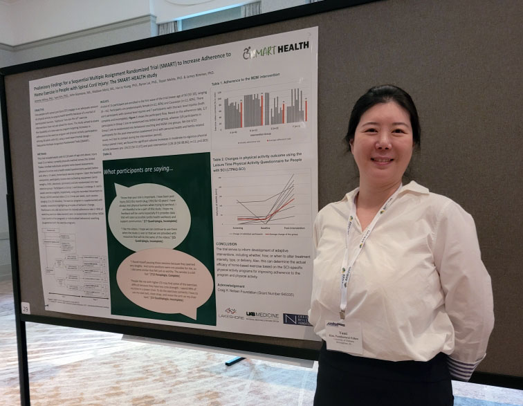 Yumi Kim beside the poster presenting her group's research. 