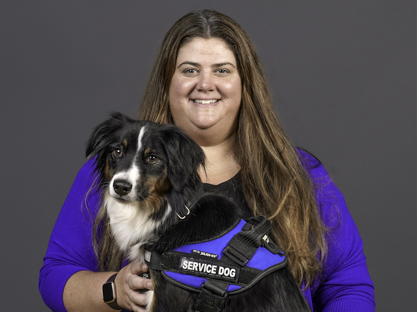Meghan Mills pictured posed with her service dog Arrow.