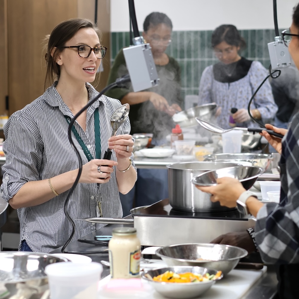 Instructor teaching class in kitchen.